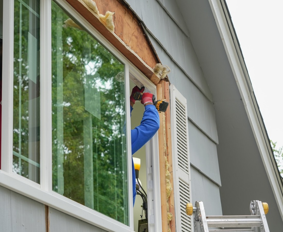 A worker installing a new window